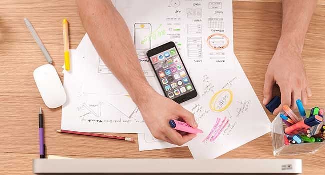 Eine Person zeichnet auf mehreren Zetteln ein Konzept f&uuml;r ein Fliphcart.