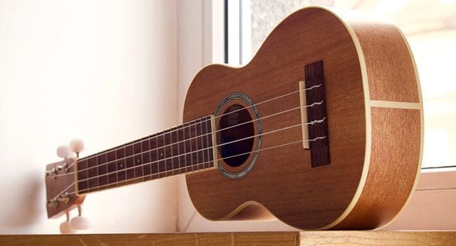 Eine Ukulele auf einer Fensterbank
